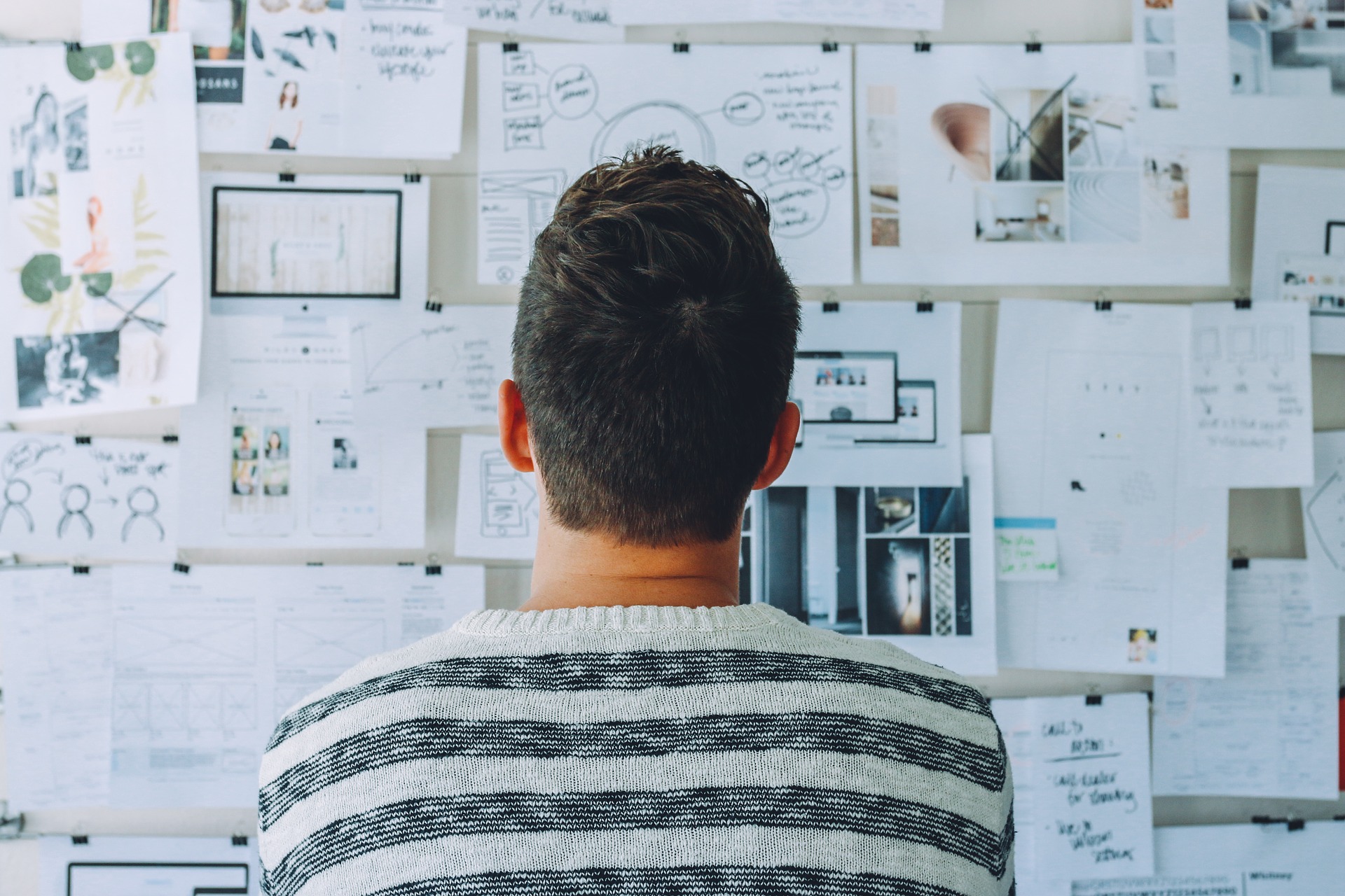 man working out marketing strategy on idea board