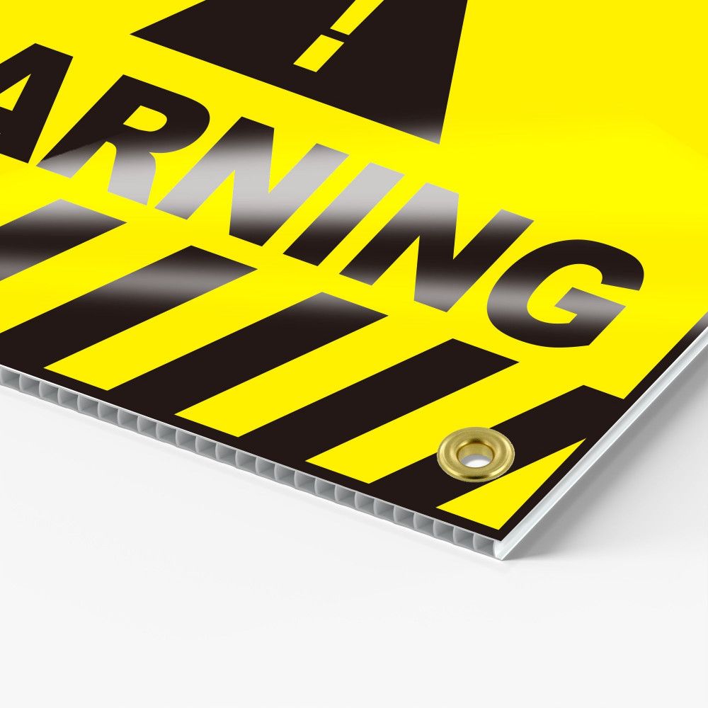 Printed coroplast sign corner with a grommet and visible flutes