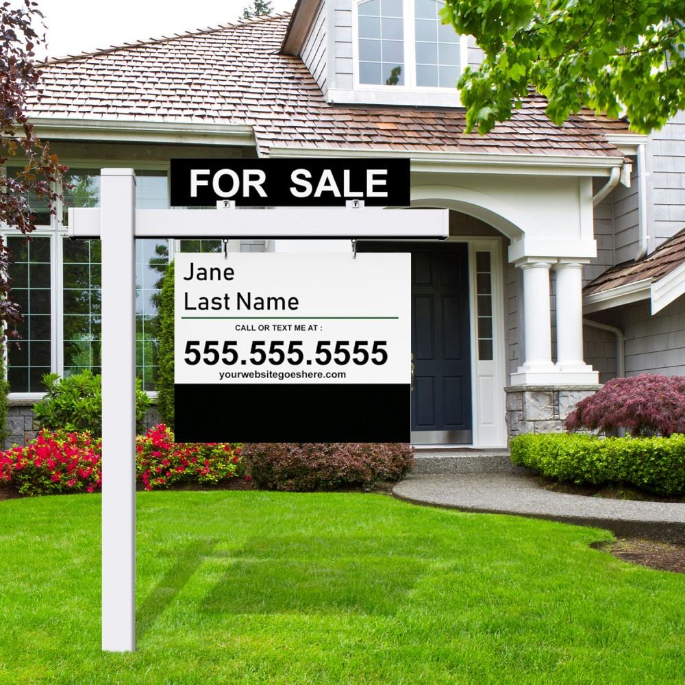 Real estate post with a hanging double sided sign and FOR SALE rider in a front yard