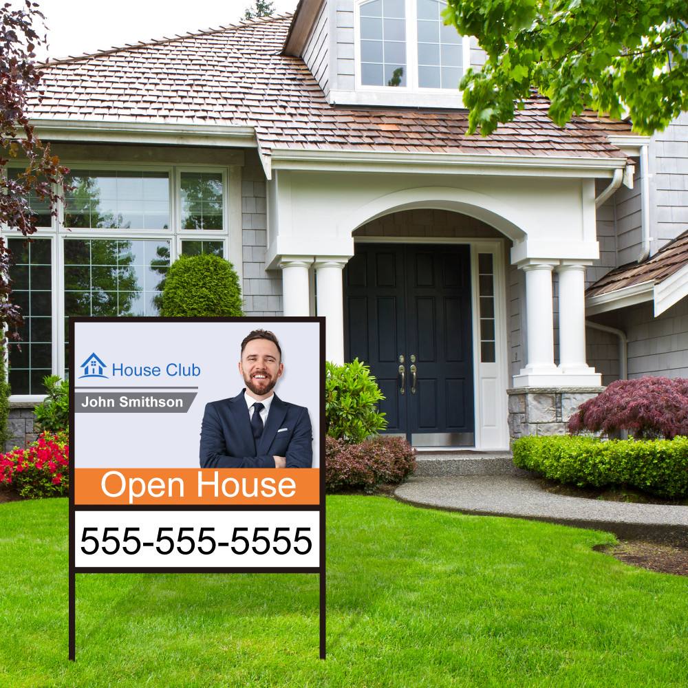 Real estate sign in a metal frame in front of a home
