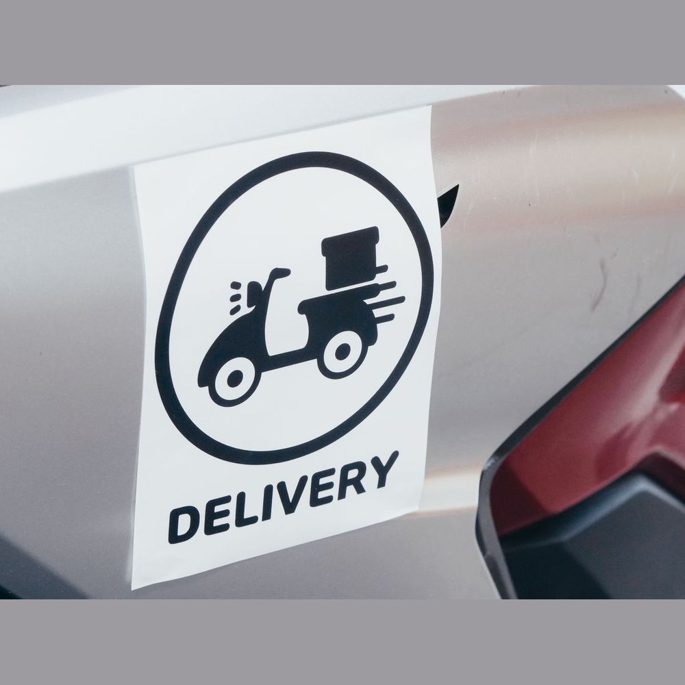 Removable vinyl delivery decal on a vehicle panel