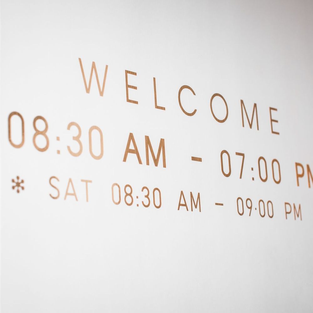 Cut vinyl business hours lettering on a wall