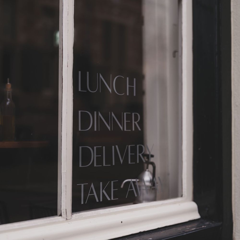 White cut vinyl lettering on a restaurant window