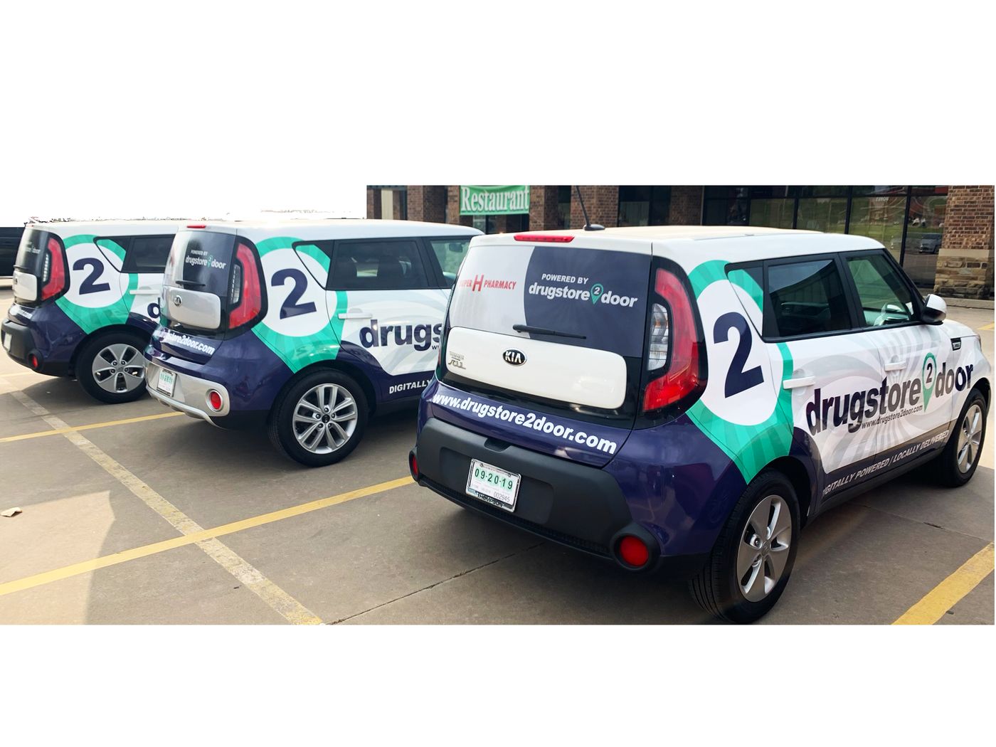 Matching fleet wraps on a row of Kia Soul cars
