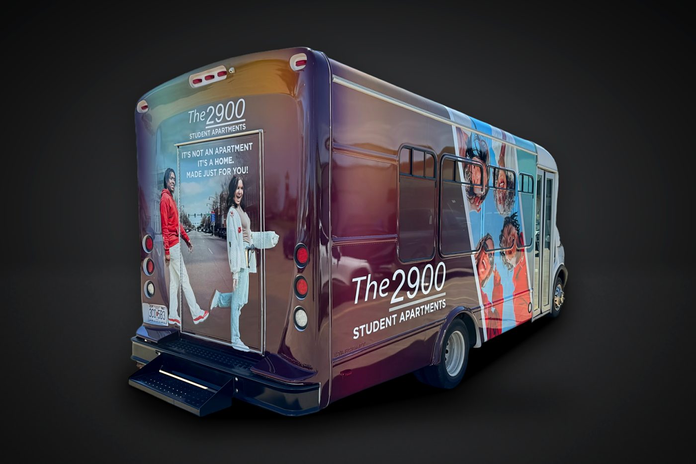 The 2900 Student Apartments full wrap on a shuttle bus, rear 3/4 view