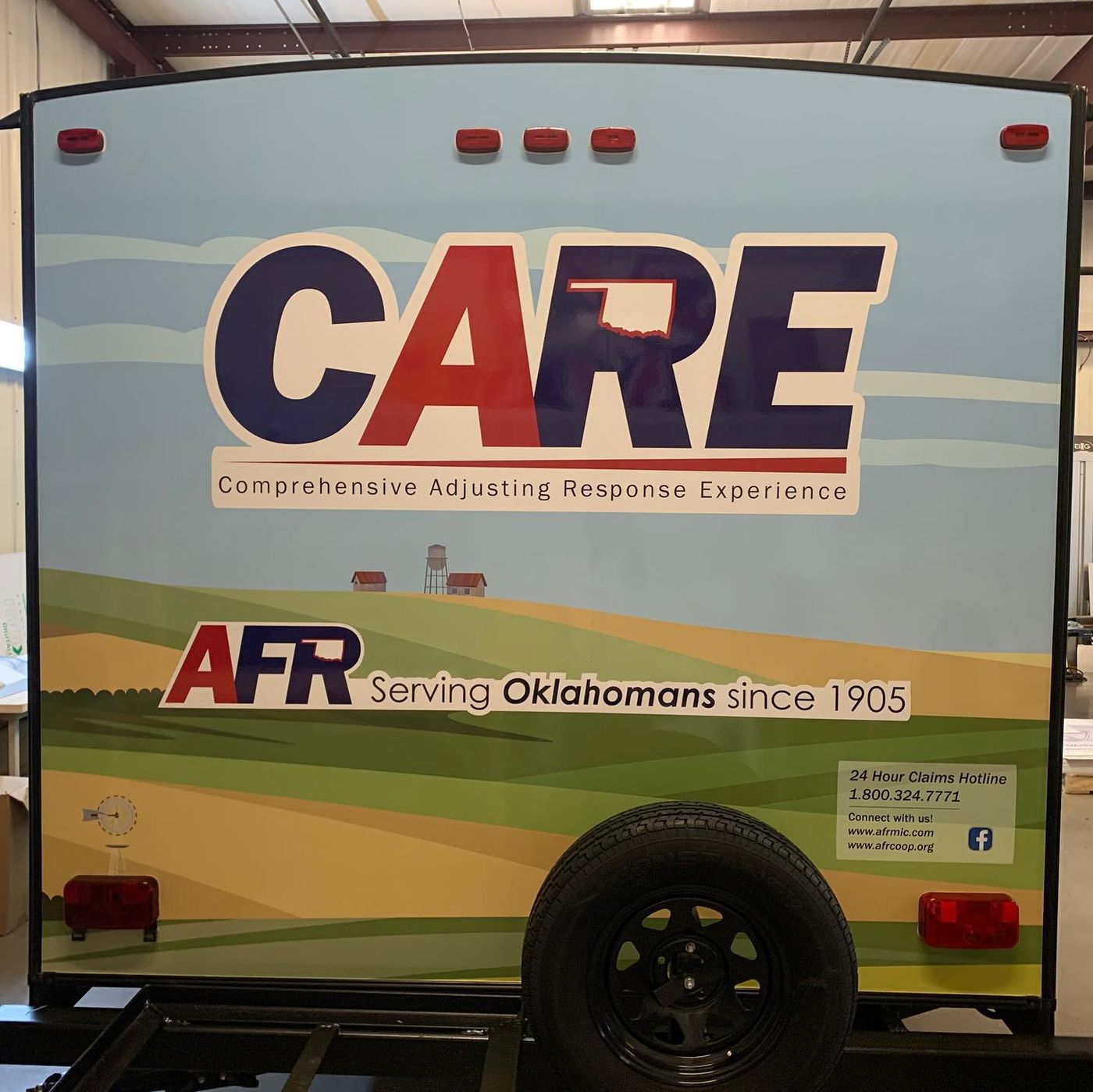 Rear of AFR CARE wrapped camper trailer