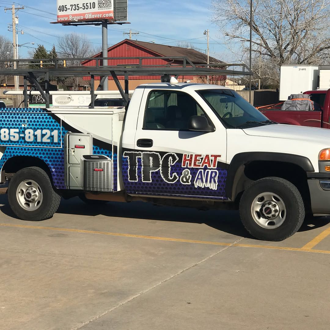 Blue graphic wrap on a utility service truck with ladder rack