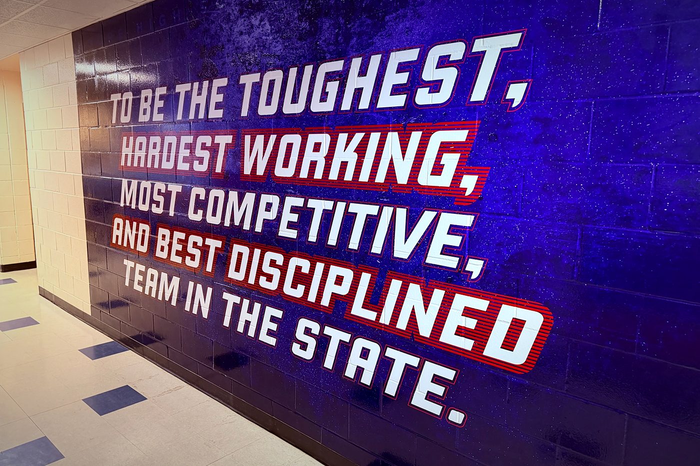 Moore High School locker room slogan wall wrap: the toughest, hardest working, most competitive and best disciplined team in the state