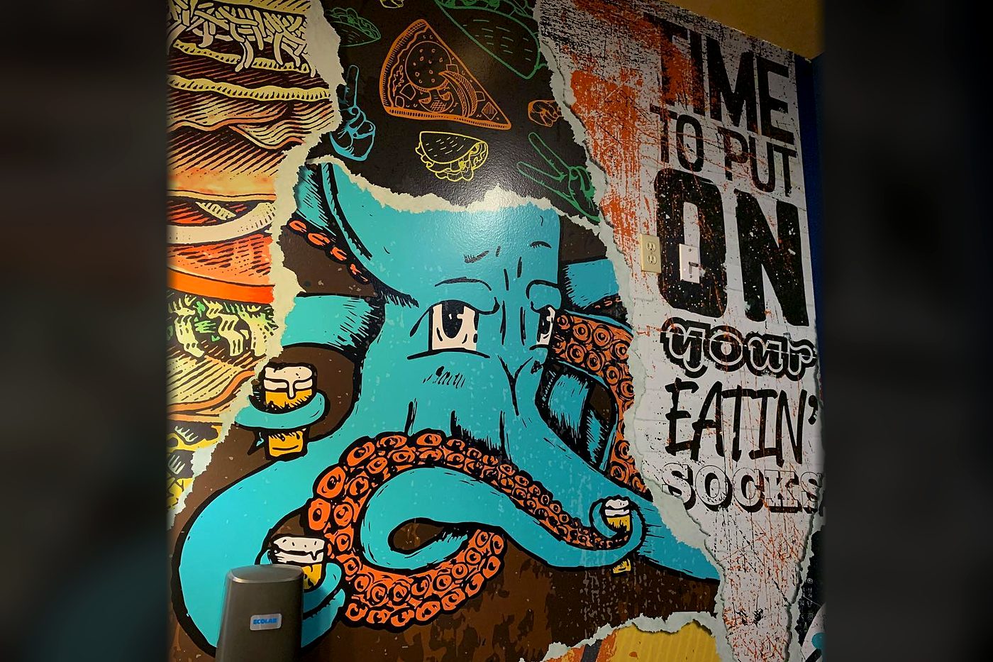 Schlotzsky's restaurant wall wrap with an octopus illustration and 'Time to put on your eatin' socks' lettering