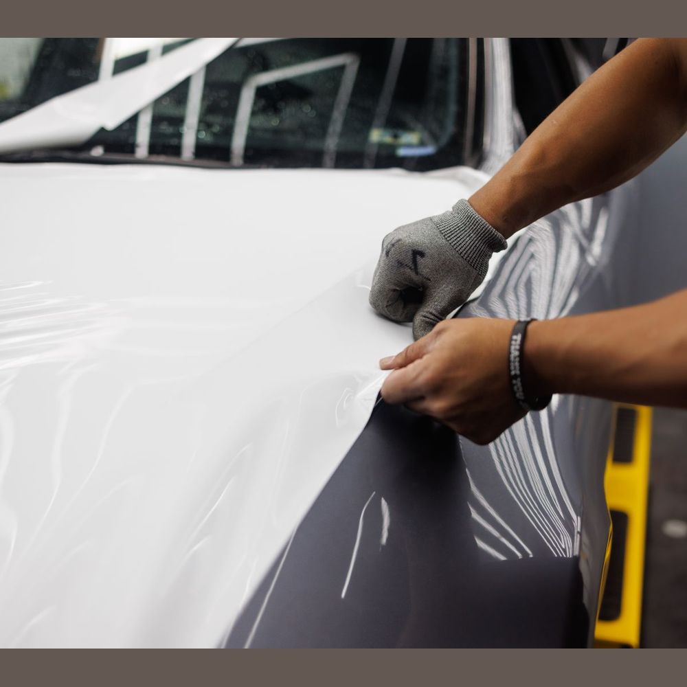 Wrap vinyl being smoothed around a panel edge