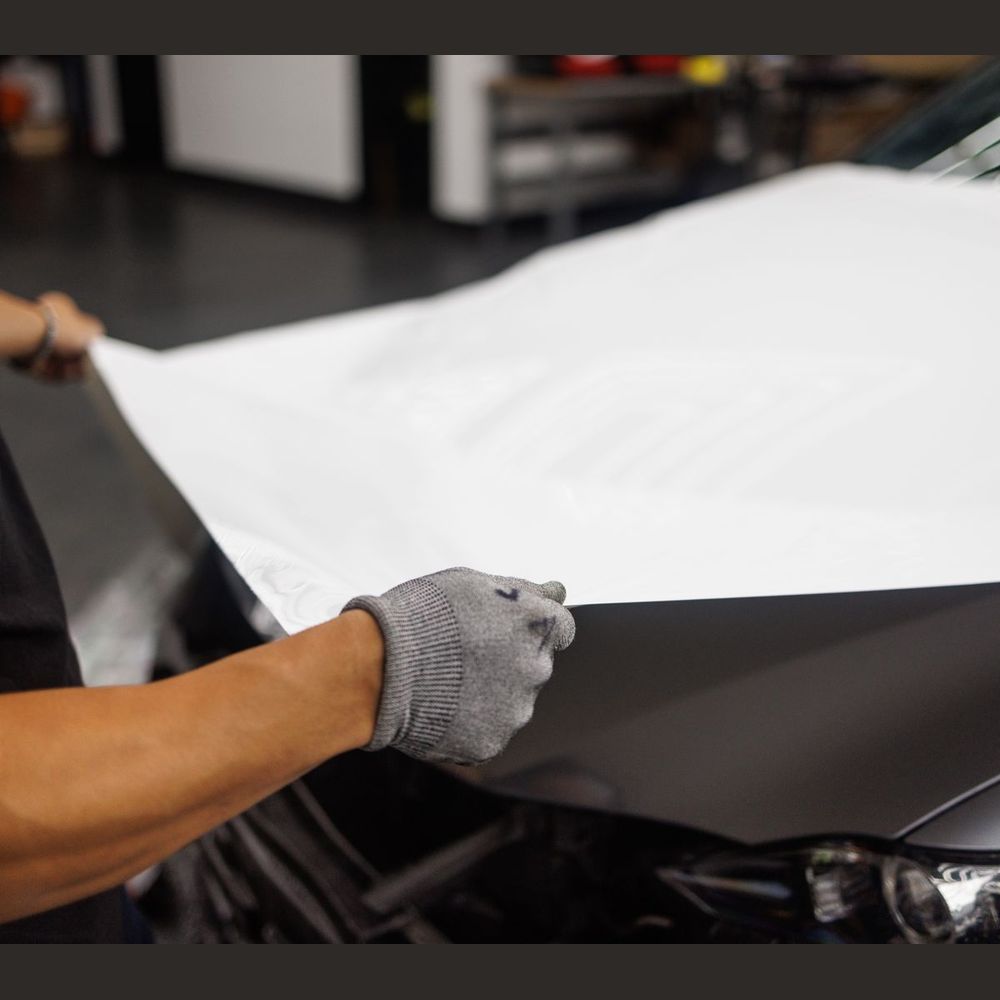Vehicle wrap vinyl stretched over a hood