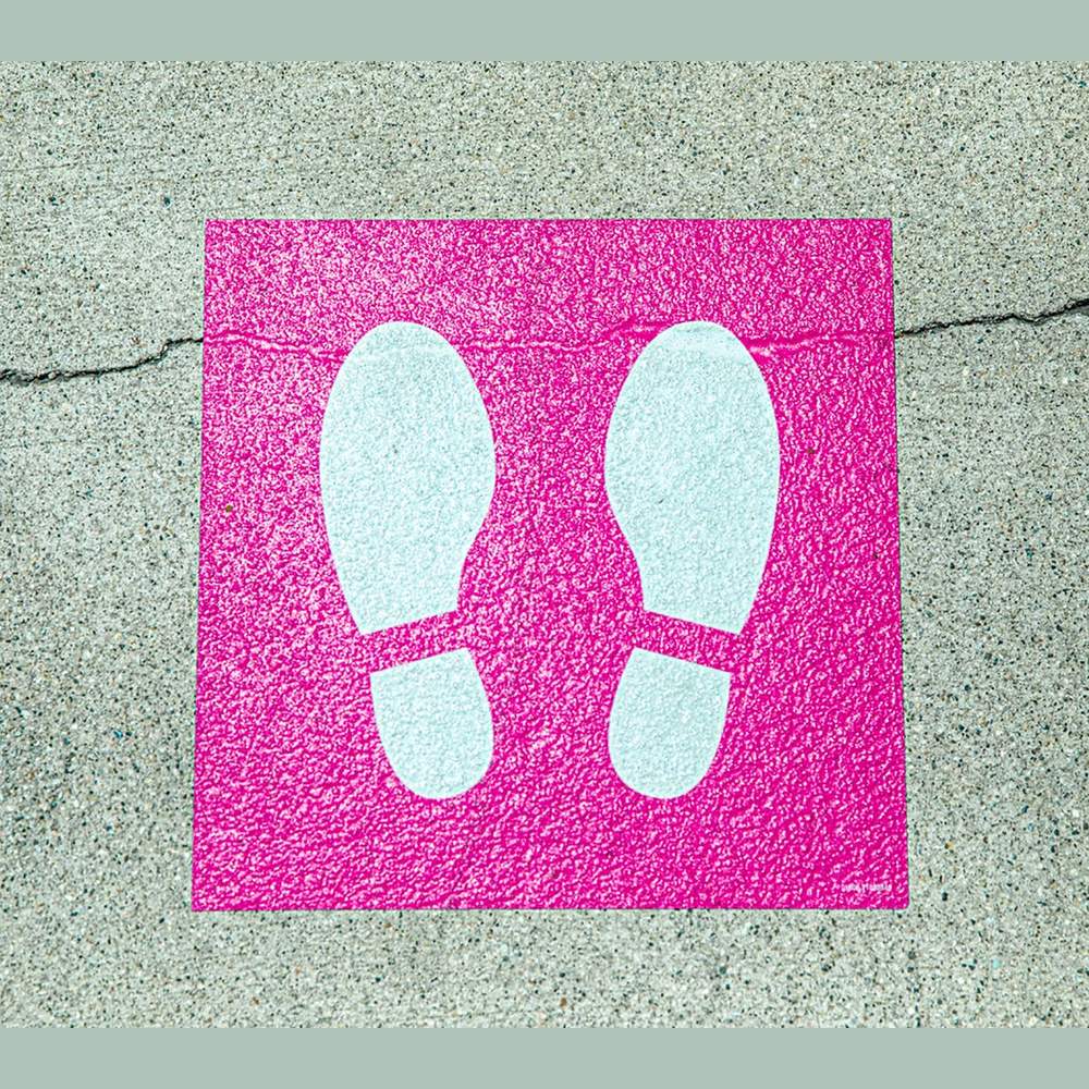 Pink footprint floor decal on concrete