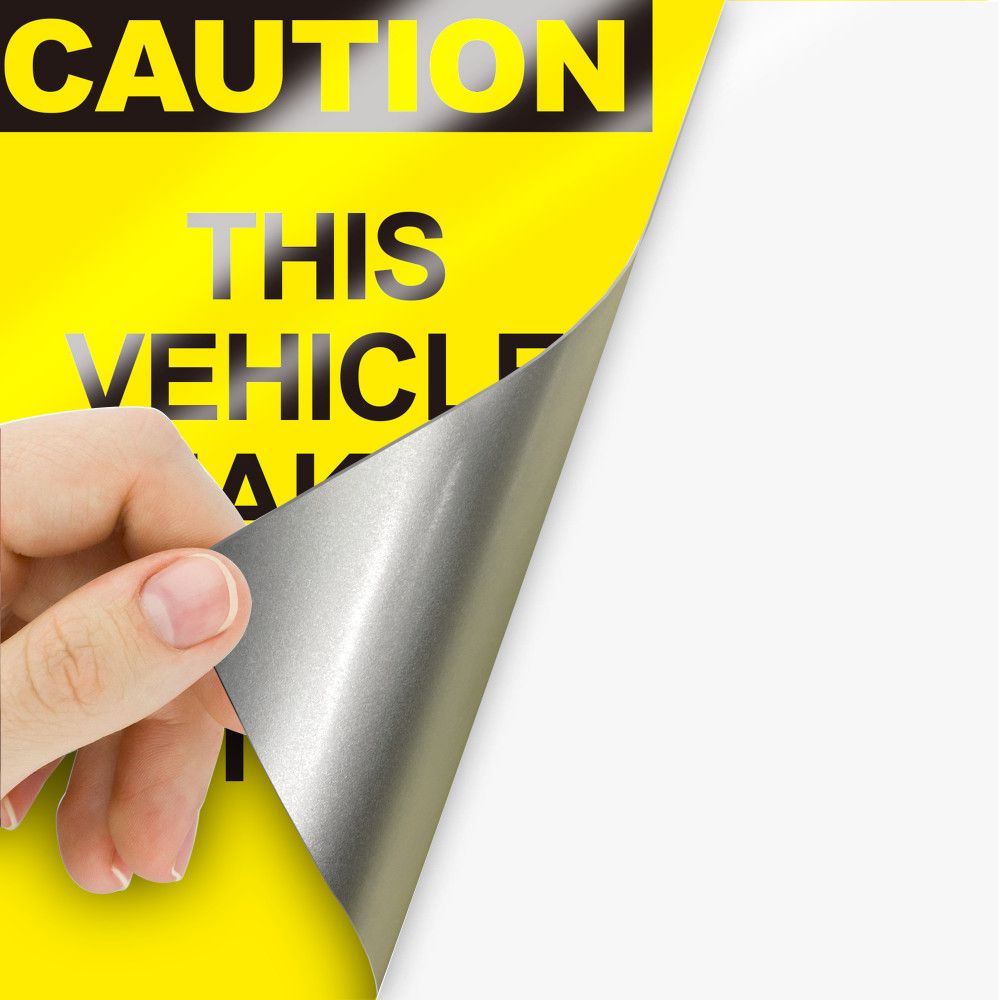 Reflective vinyl caution decal peeling from its liner