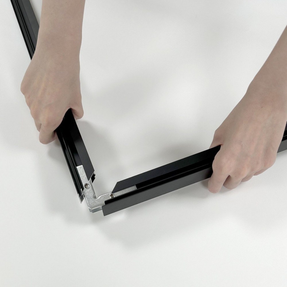 Assembling the black aluminum SEG frame corners