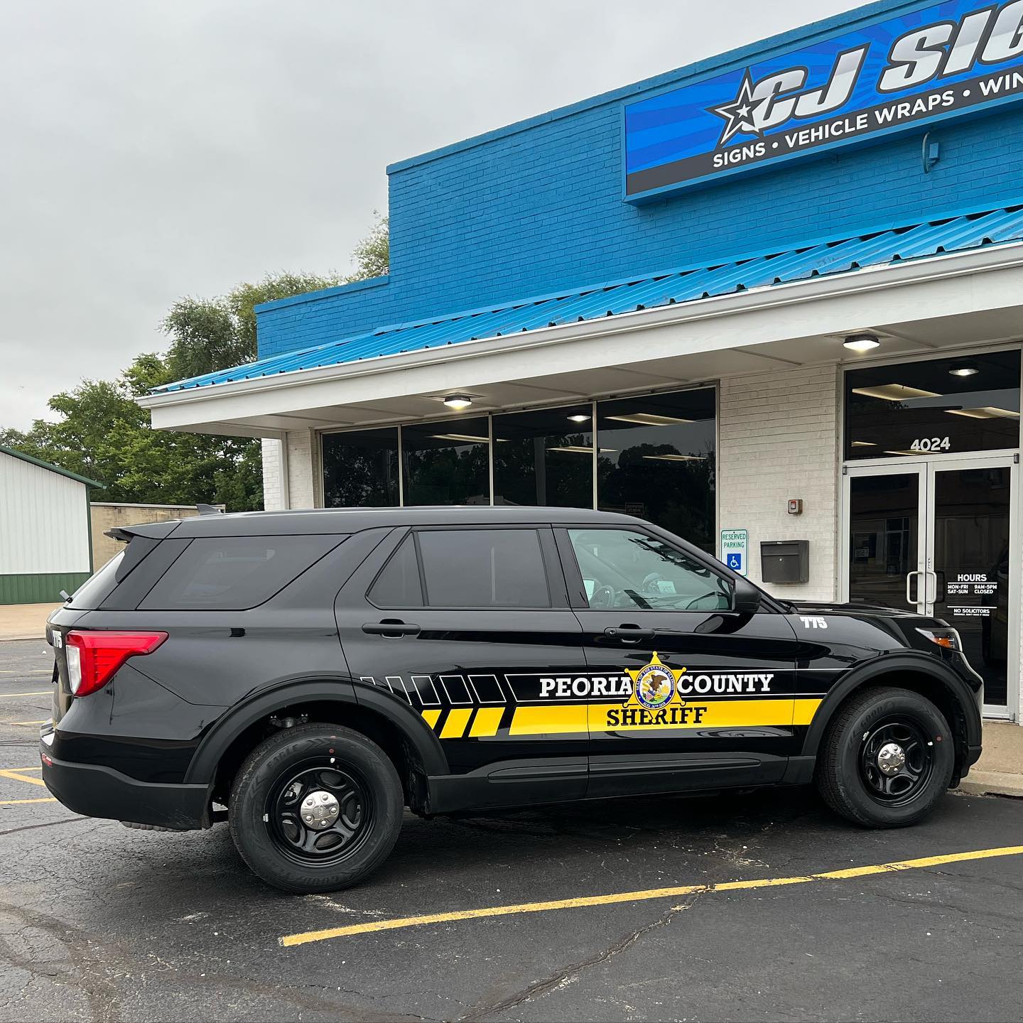 CJ Signs shop in Peoria, IL with Peoria County Sheriff vehicle graphics installed