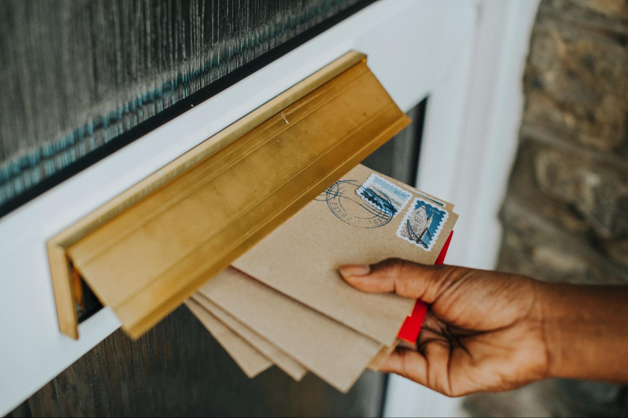 Mail being delivered through a mail slot